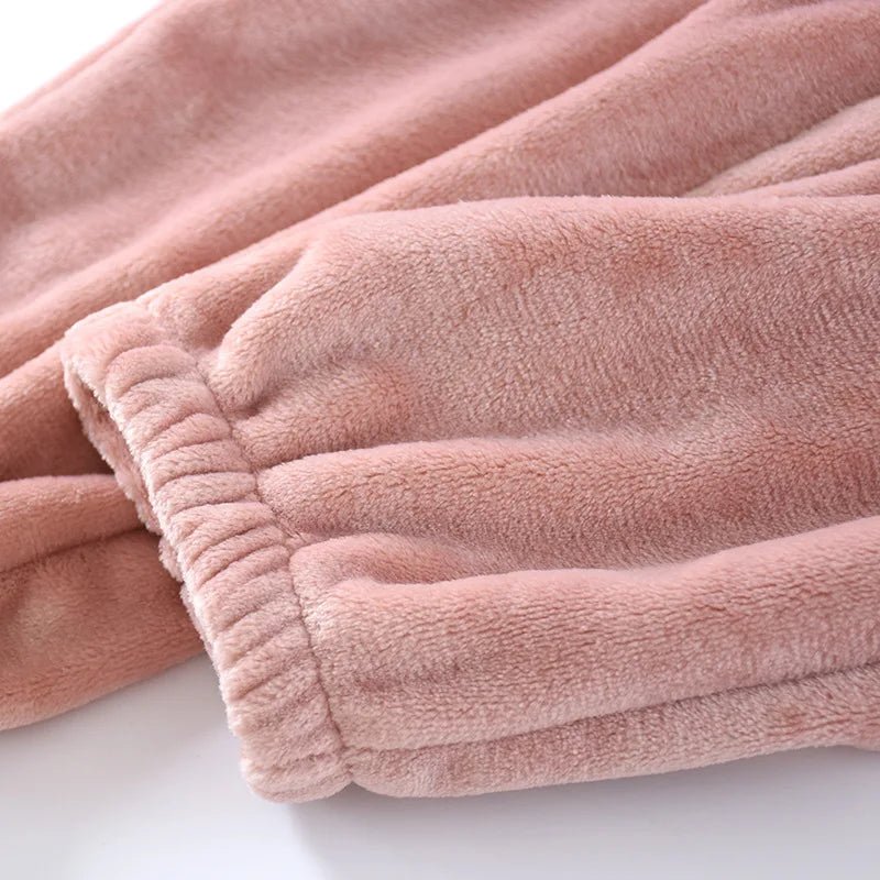 Gros plan sur le bas resserré du pantalon de pyjama rose
